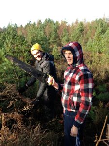 Matt being "helped" by Alex with cutting down the Christmas tree on Winterfold Heath