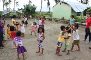 Children playing the "running to shelter" game at a child-friendly space operated by Save The Children