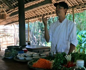 Getting a mix of advice and abuse from our chef tutor at the Red Bridge Cookery School in Hoi An